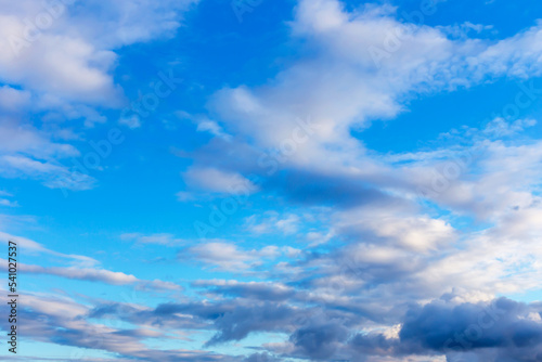 Dark and white fluffy clouds in the blue sky