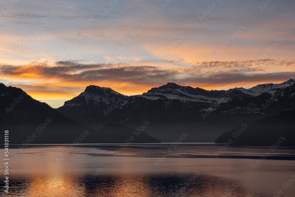 Beautiful sunset behind the mountions at the lake lucerne with some clouds