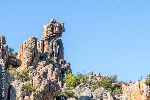 Rock formation, resembling a person sitting on a chair photo