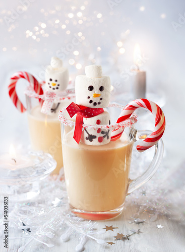 Traditional Christmas Eggnog with sweet treat snowman marshmallow and candy cane peppermint
