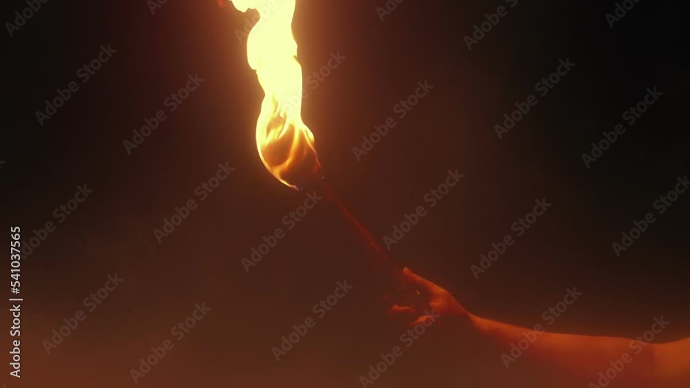 Flaming Torch Is Held Up In Thick Mist
