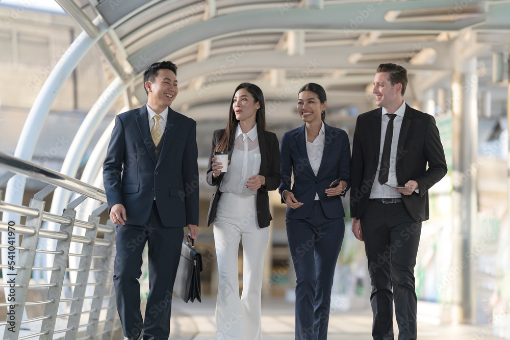 Business people walking and talk to each other in front of modern office Business people walking and talk to each other in front of modern office
