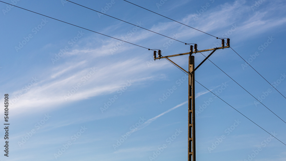 Minimalistic picture of electrical pole with cloudy sky in background Minimalistic picture of electrical pole with cloudy sky in background