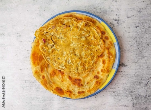 anda paratha or omelet paratha served in a plate isolated on background top view of indian and pakistani desi food photo