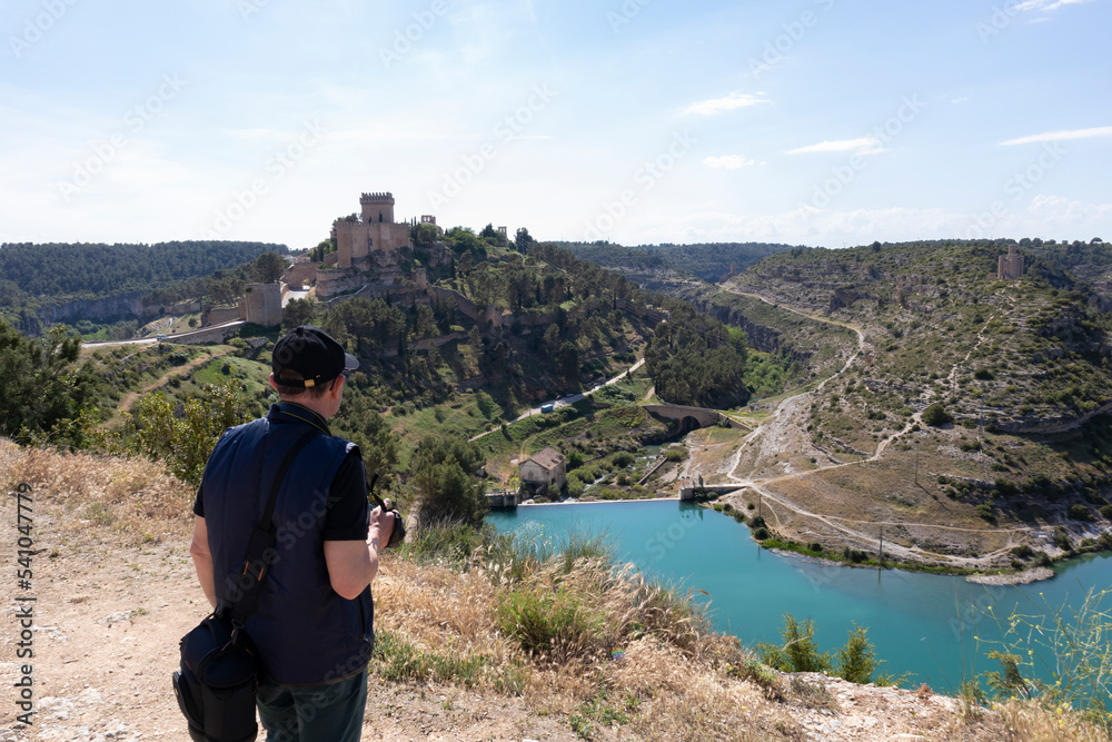 view of the castle from the top and with a river route next to it, places to visit an old castle with history and to make routes.