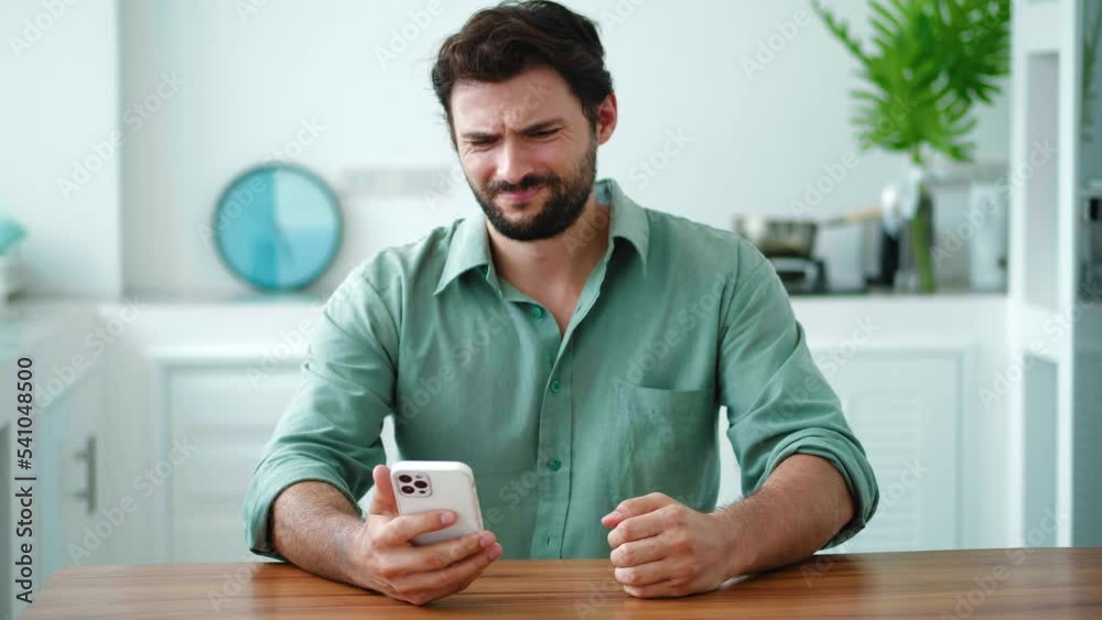 Concerned worried annoyed angry millennial Hispanic young man holding smartphone, feeling outraged by low wifi internet signal, bad connection, application crash. Software problems on cell phone Concerned worried annoyed angry millennial Hispanic young man holding smartphone, feeling outraged by low wifi internet signal, bad connection, application crash. Software problems on cell phone
