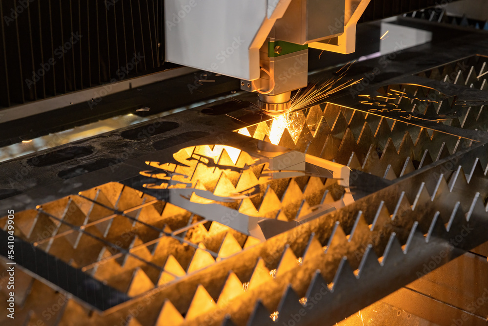 Laser cutting machine for metal sheet in action with melted metal sparks  Stock 写真 | Adobe Stock