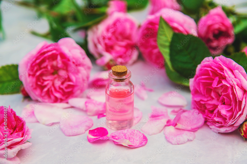 Rose essential oil in a bottle. Selective focus. Rose essential oil in a bottle. Selective focus.