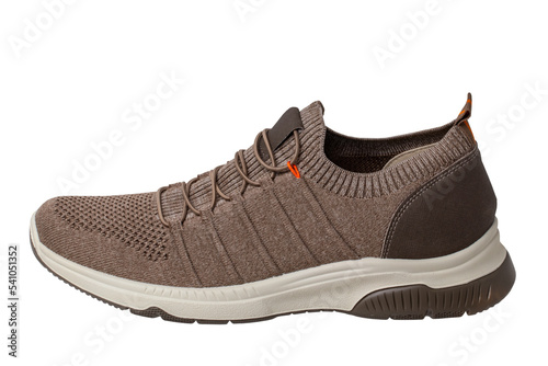 Closeup of a single of modern brown sneaker or sports shoe isolated on a white background. Clipping path. Elegant and trendy mans shoe. Macro.