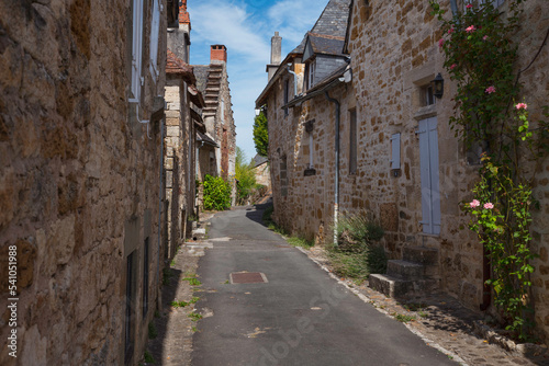 a street with old limestone houses in Turenne france