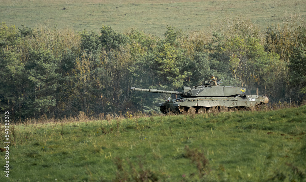 British army Challenger II 2 FV4034 main battle tank in action crossing open grass fields, on a military exercise Wiltshire UK British army Challenger II 2 FV4034 main battle tank in action crossing open grass fields, on a military exercise Wiltshire UK
