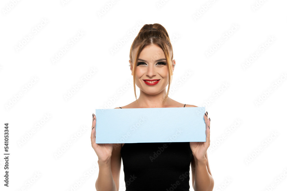 Smiling woman holding blue billboard for advertising sign on a white background Smiling woman holding blue billboard for advertising sign on a white background
