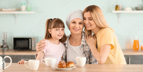 Happy mature woman after chemotherapy with her family in kitchen