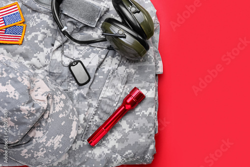 Military uniform, headphones, flashlight, tag and chevrons of USA army on red background