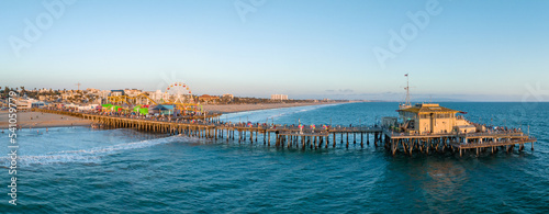 Famous Santa Monica ferris wheel amusement park in sunset light. Panoramic view of the Santa Monica Beach and the Pier