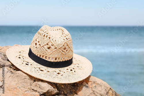 Woven straw hat with black ...