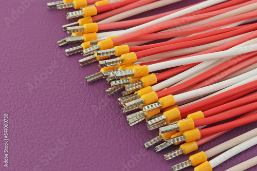 Copper electrical wires in colored insulation on a colored background.