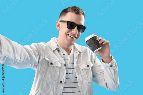 Young man with cup of coffe...