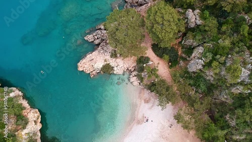 The girl swims in the blue water. Panoramic view of Pirate bay or Korsan Koyu near Karaoz, Antalya. Summer and Holiday background. photo