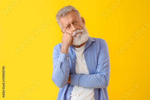 Thoughtful mature man on ye...