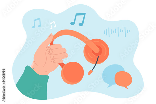 Hand holding headphones for listening to music. Person enjoying sound, radio playlist with headset flat vector illustration. Entertainment concept for banner, website design or landing web page
