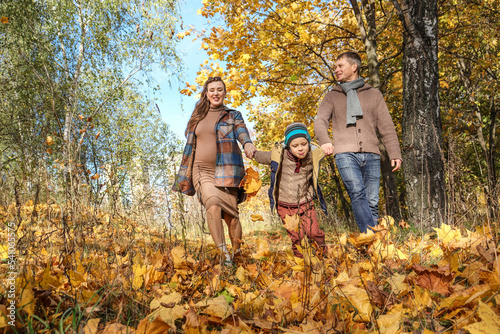 happy family walking in autumn park.