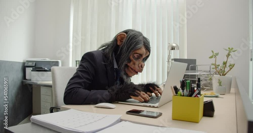 Monkey Businessman in Office typing on computer