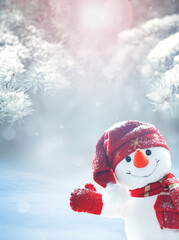 Merry christmas and happy new year greeting card .Happy snowman standing in winter christmas landscape. Snow background
