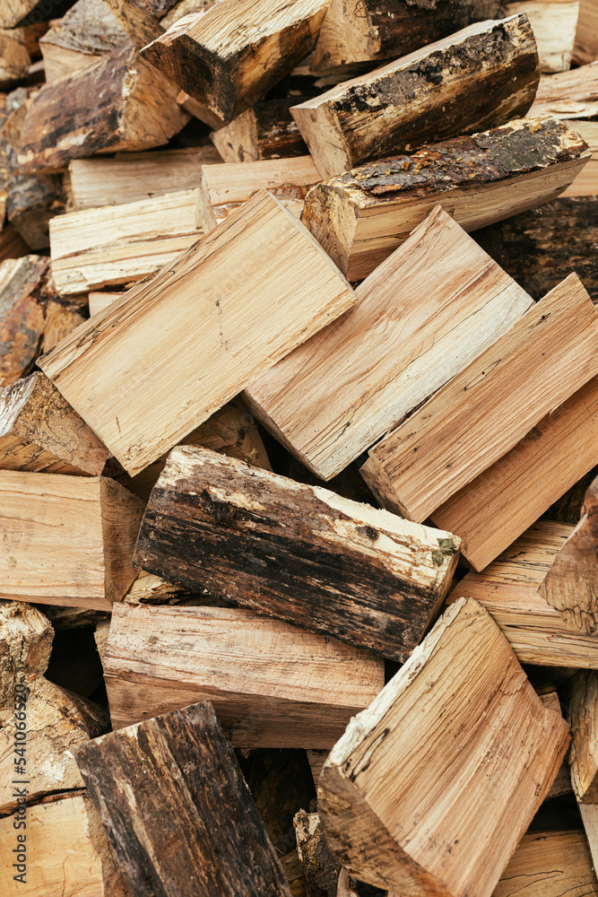 Firewood. Stack of firewood close up, wooden background. Chopped wood for fireplace heating, alternative to gas and electricity. Lumber pattern, log Firewood. Stack of firewood close up, wooden background. Chopped wood for fireplace heating, alternative to gas and electricity. Lumber pattern, log