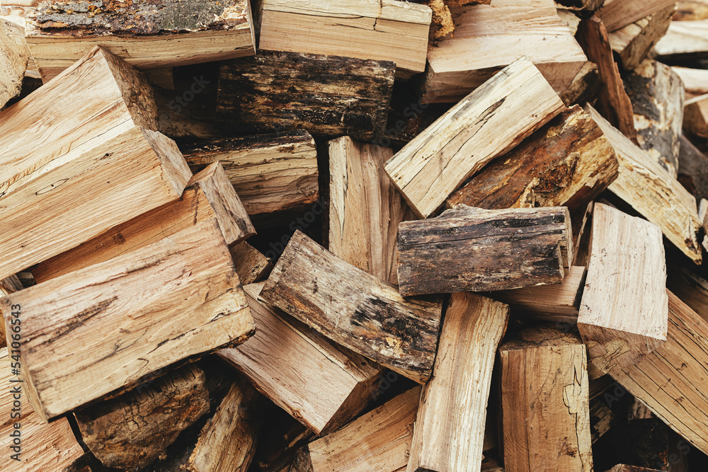 Firewood. Stack of firewood close up, wooden background. Chopped wood for fireplace heating, alternative to gas and electricity. Lumber pattern, log Firewood. Stack of firewood close up, wooden background. Chopped wood for fireplace heating, alternative to gas and electricity. Lumber pattern, log