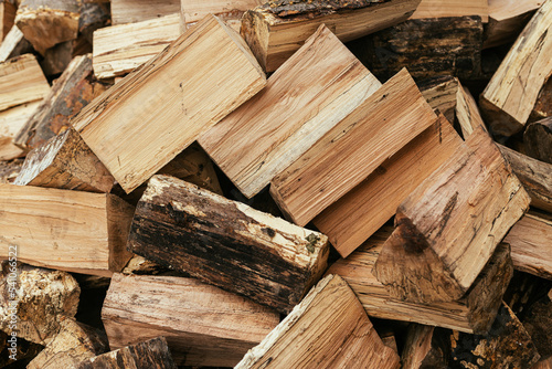 Firewood. Stack of firewood close up, wooden background. Chopped wood for fireplace heating, alternative to gas and electricity. Lumber pattern, log