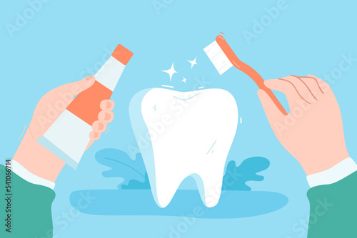 Hand holding toothbrush and toothpaste. Person brushing huge tooth, taking care of health on blue background flat vector illustration. Hygiene, oral cavity, treatment, medicine concept
