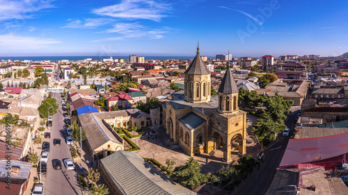 Aerial drone view to old town Derbent, caspian sea and Armenian Church of the Holy Saviour Surb Amenaprkich. Now Museum of Carpet and Decorative and Applied Arts. Republic of Dagestan, Russia