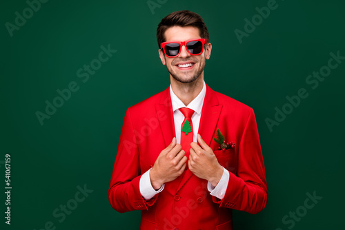 Photo of sweet charming santa claus guy dressed red jacket glasses preparing x-mas party isolated green color background