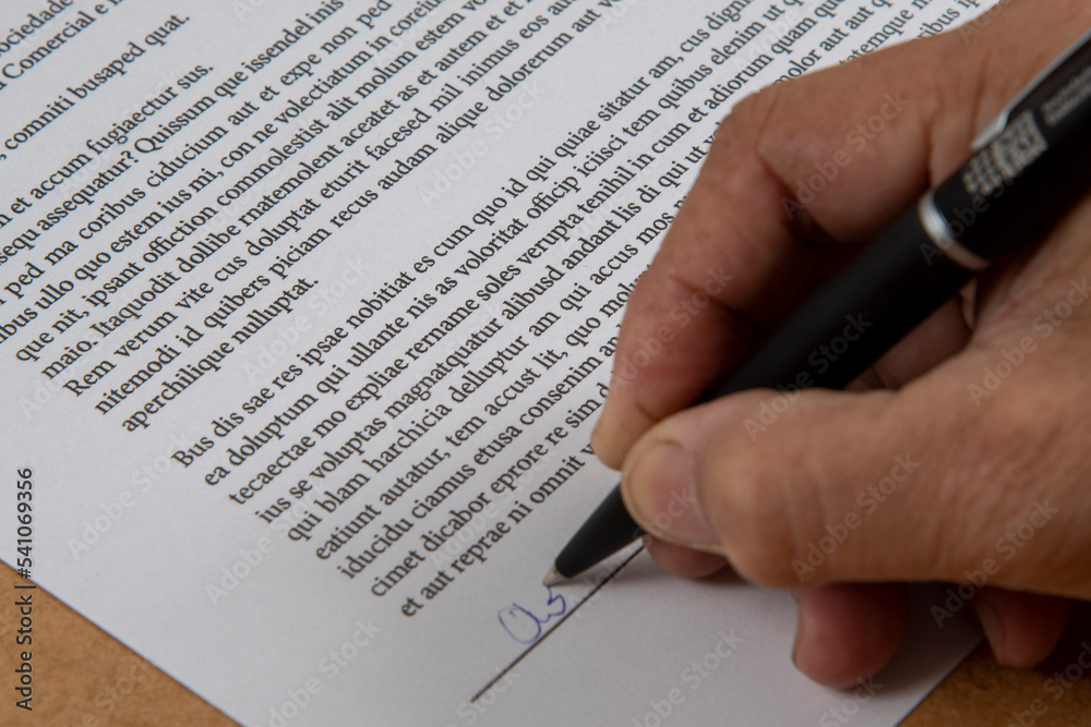 printed document signature showing a hand and ballpoint pen. printed document signature showing a hand and ballpoint pen.