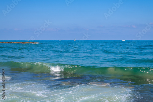Overview of beach and wave breakers, jetties on the coastline of the Mediterranean Sea in Tel Aviv, Israel. 