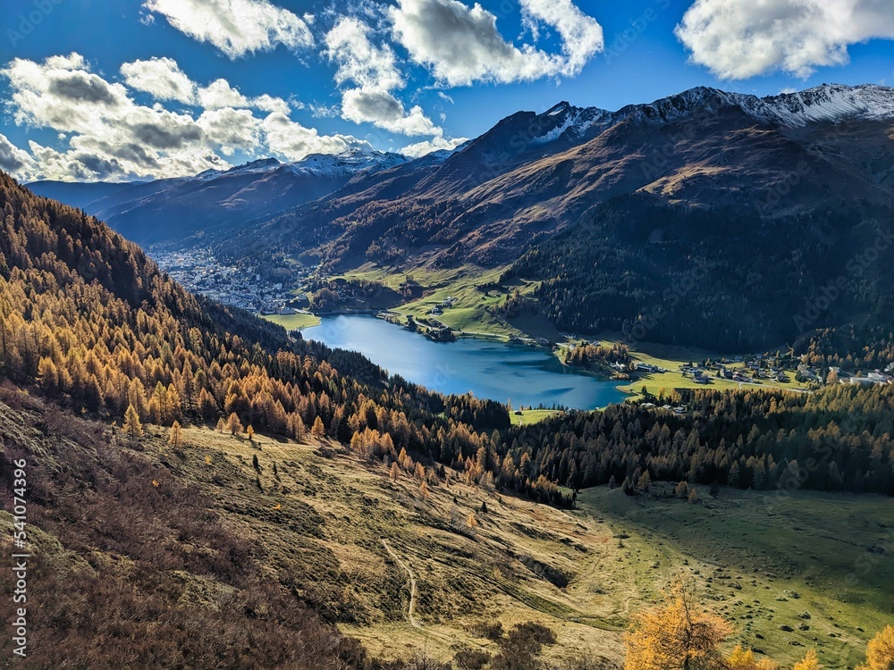Autumn in Graubunden Switzerland in Davos Klosters. Hiking in the mountains surrounded by the colored forests. High quality photo