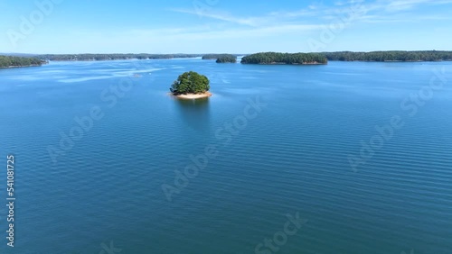 4K Drone footage of Lake Lanier in North Georgia, aerial drone on a sunny fall day. Clear view of fall colored trees and blue lake water.