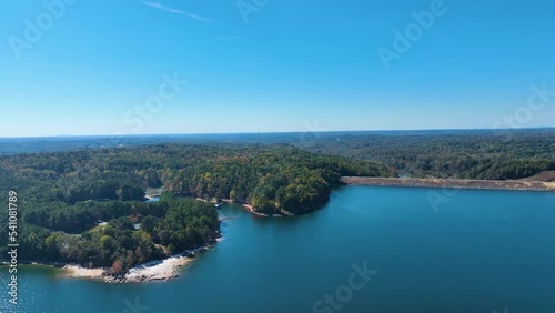 4K Drone footage of Lake Lanier in North Georgia, aerial drone on a sunny fall day. Clear view of fall colored trees and blue lake water.