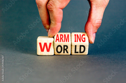 Warming world symbol. Concept words Warming world on wooden cubes. Beautiful grey table grey background. Businessman hand. Business, ecological and warming world concept. Copy space.