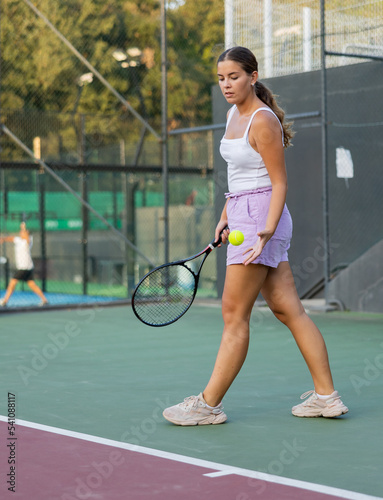 Tennis game - girl getting ready to hit the ball with a racket © JackF