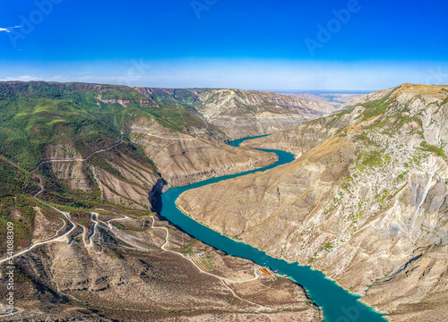 Aerial drone view to deep Sulak canyons. Stunning curving turquoise river among mountains. Picturesque panoramic landscape to valley. The deepest canyon in the world. Sights Dagestan Russia, Europe photo