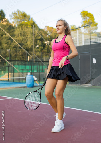 Portrait of sporty focused woman playing on court, ready to hit ball. Active lifestyle concept © JackF