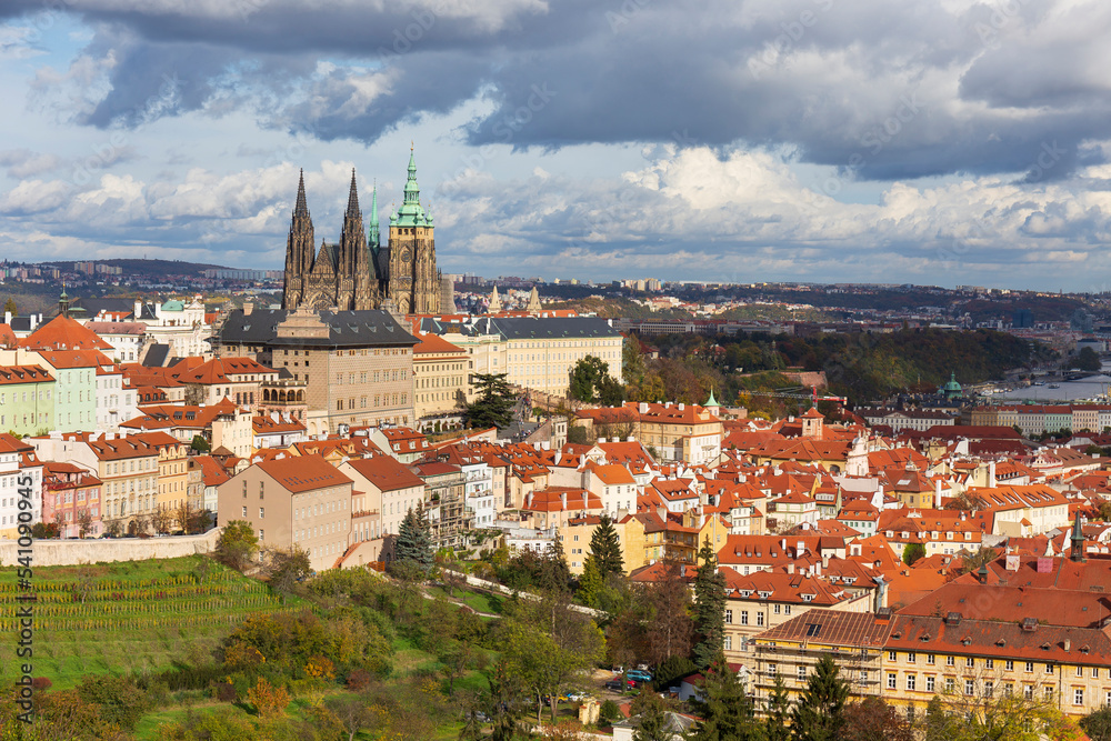 Autumn Prague City with gothic Castle, colorful Nature and Trees and dramatic Sky from the Hill Petrin, Czech Republic