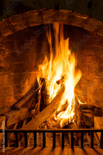 Burning woods in a brick fireplace