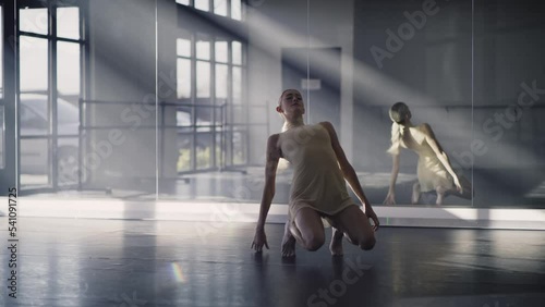 Woman practicing contemporary dancing on floor of dance studio / Lehi, Utah, United States photo