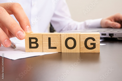 man made word blog with wood blocks on the background of the office table. selective focus. business concept.