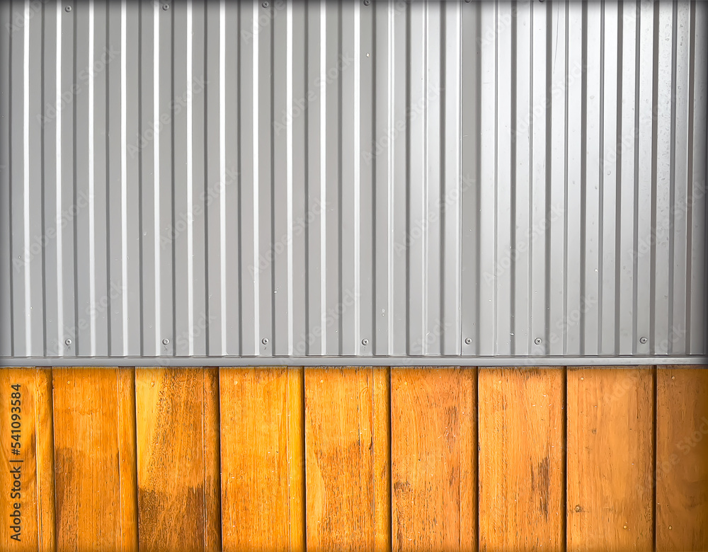 Grey , shiny, smooth corrugated aluminium sheeting at the top against