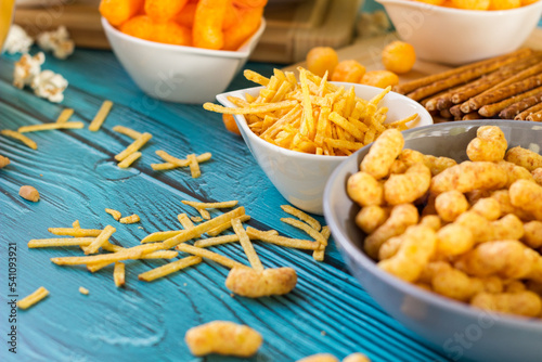 Beer salty snacks on wooden table