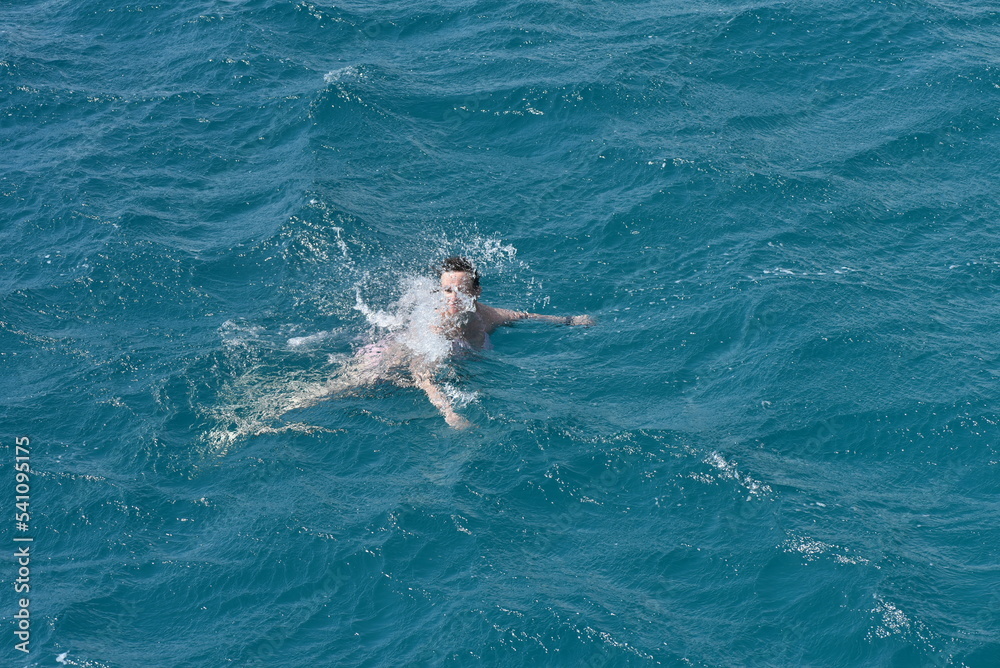 person swimming in the sea